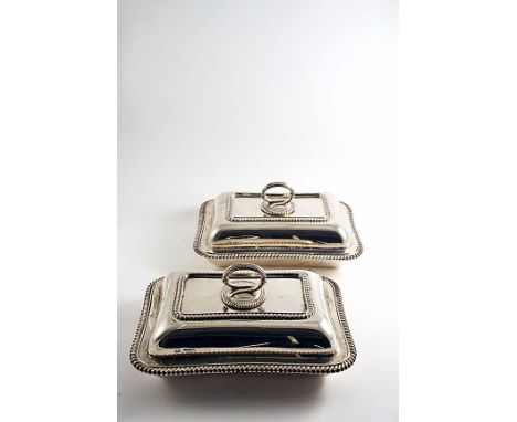 A PAIR OF EARLY 20TH CENTURY RECTANGULAR ENTREE DISHES & COVERS with gadrooned borders, and detachable reeded handles, creste