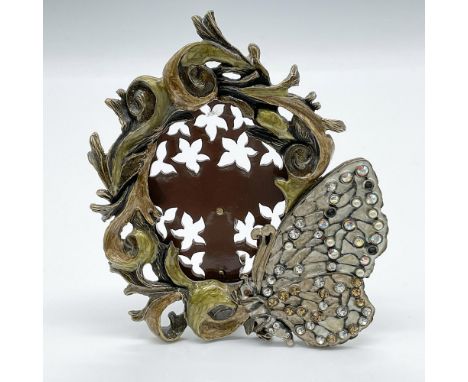 This lovely little frame has an enamel vine border in gold and green set in brass tone metal. At the side of the frame is lar