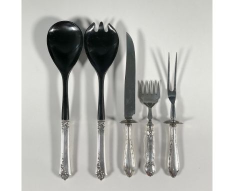 A sterling silver set comprising of a salad fork and spoon made of black plastic spoon and fork with sterling handles, a cold