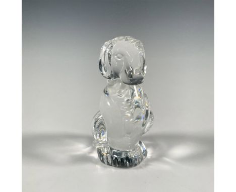 Clear glass crystal figure modeled as an alert dog in seated position. Steuben etched backstamp. Dimensions: 1.75"L x 1.75"W 