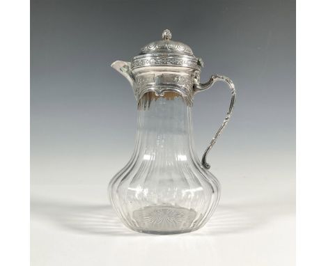 Unmarked, early 19th century French water pitcher with silver handle, lid, and spout. Silver is engraved with foliage decorat