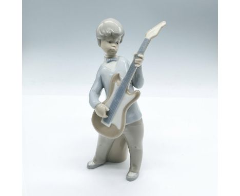 Practice makes perfect for this charming piece of a boy strumming his guitar. The bongo behind the boy is next. Glossy finish