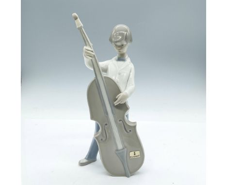 Charming boy intently playing his base. Glossy finish. Lladro Hand Made in Spain backstamp. Lladro foil sticker on front. Art