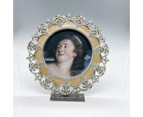 Beautiful round frame fit for a queen. The scalloped golden enamel has lots of movement. The outer edge is an intricate silve