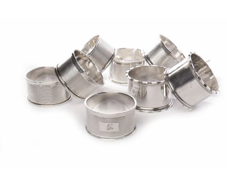 SET OF SIX SILVER NAPKIN RINGSwith engine turned decoration each bearing a different initial, maker Harman Brothers, Birmingh