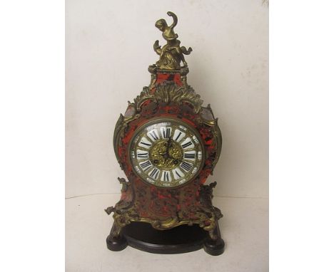 A late 19th/early 20th century French boulle work mantle clock with gilt metal dial having white enamel and black Roman numer