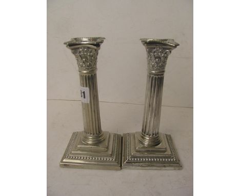 A pair of silver plated Corinthium column candlesticks on stepped bases, 6 1/2