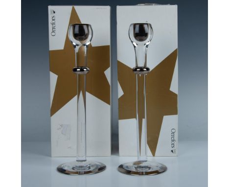 Two elegant crystal candlesticks, flawlessly smooth and accented with platinum frames for a touch of luxury. This item has it