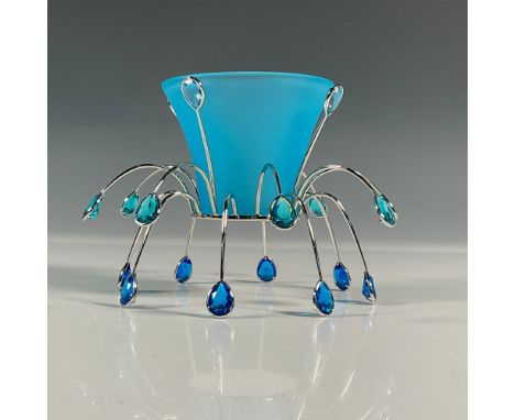 Delicate tea light that was part of the Crystal Jewels collection. A blue satin bowl that sits on a silver-tone metal base de