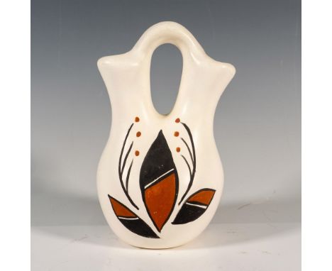 A small white hand painted double-spout vase decorated with an abstract leaf design in brown and black colors. Artist: B. Kai