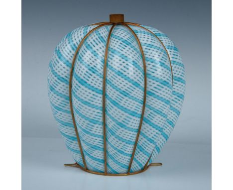 This hand-blown light shade features a powder blue and white color scheme, with a bulbous body enclosed by a brass-colored ca
