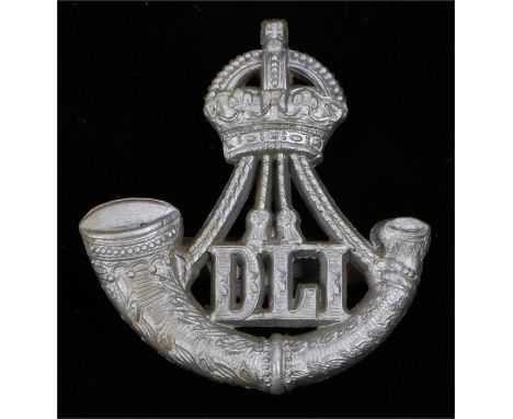 World War Two plastic economy cap badge to the Durham Light Infantry, in silver grey, two blades to the reverse, K&K 2256