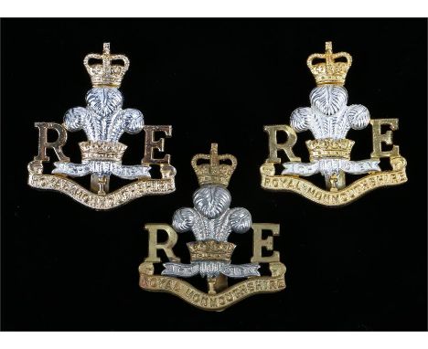 Three Elizabeth II Royal Monmouthshire Royal Engineers cap badges, bi metal with sliders to the reverse, anodised aluminium e