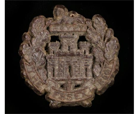 World War Two plastic economy cap badge to the Essex Regiment, in chocolate brown, two blades to the reverse, marked 1 - A an