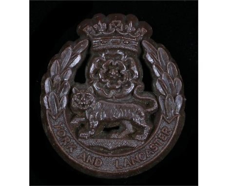 World War Two plastic economy cap badge to the York and Lancaster Regiment, in chocolate brown, two blades to the reverse, ma