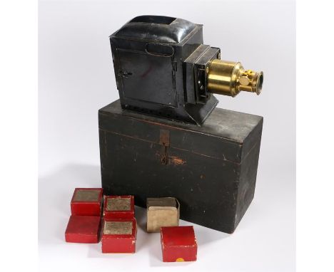 Magic lantern projector with three wick lamp and brass mounted lens, together with six boxes of slides, three labelled Natura