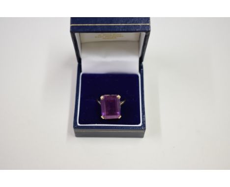 A 9ct gold rectangular amethyst ring; together with another example set sapphire; and a 9ct gold cameo ring, (3). 