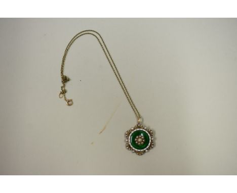 A late Victorian unmarked guilloche enamel and seed pearl pendant, on an unmarked chain. 