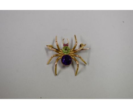 A 15ct gold spider brooch, the body set amethyst, peridot and having ruby eyes,&nbsp;4.4g total weight. 