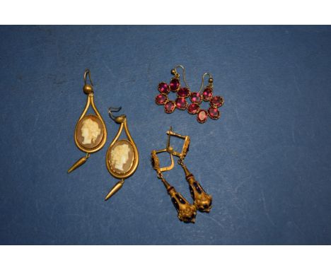 Three pairs of Victorian pendant earrings,&nbsp;a floral set garnet&nbsp;pair; an enamel and silver gilt pair; and an etrusca