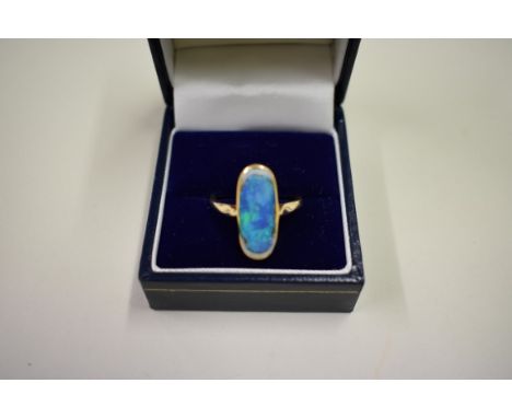 A 9ct gold blue topaz set ring; together with an unmarked gold opal ring. 