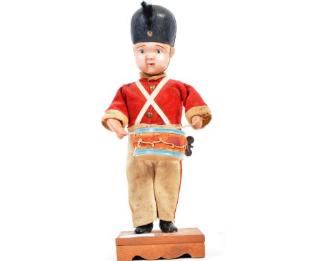 An original 20th Century retro vintage Japanese Celluloid clockwork wind up drummer boy toy wearing a military uniform with d