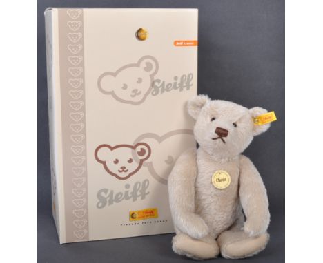 An original German Steiff made ' Classic ' edition soft toy teddy bear. The bear having a yellow tag and gold button to the l