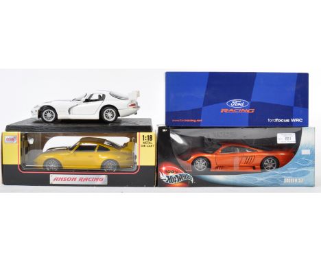 A collection of x4 assorted 1/18 scale precision diecast model cars by makers Hot Wheels, Anson, Maisto and Action. Models to