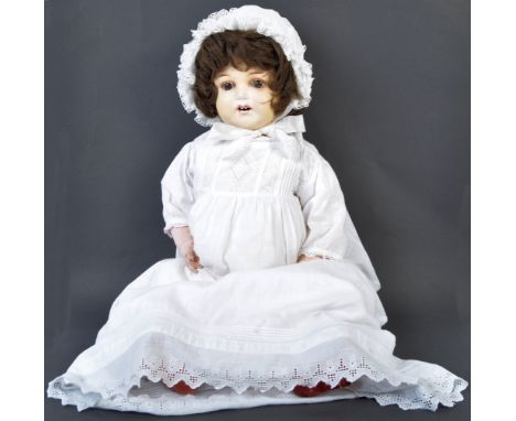 An antique early 20th century German made Armand Marseille bisque headed doll. The doll having brown fixed eyes, finely paint
