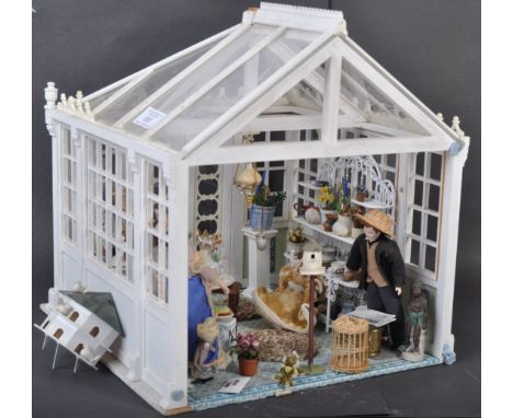 A charming vintage doll's house in the form of a Victorian conservatory / orangery. Beautifully made with perspex panels and 