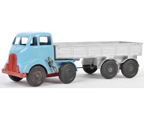 An original vintage Mettoy made clockwork diecast model of a 8 wheel flatbed articulated lorry / truck. The blue truck with k