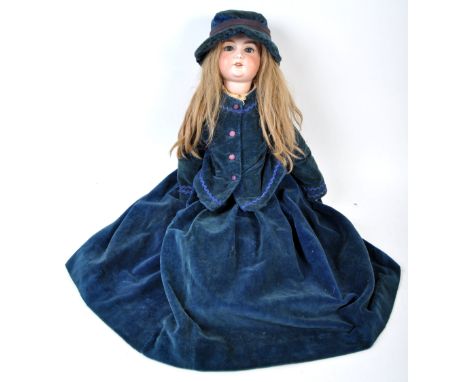 A large early 20th century antique German made Armand Marseille bisque headed doll. The doll having blue flirty eyes, soft br