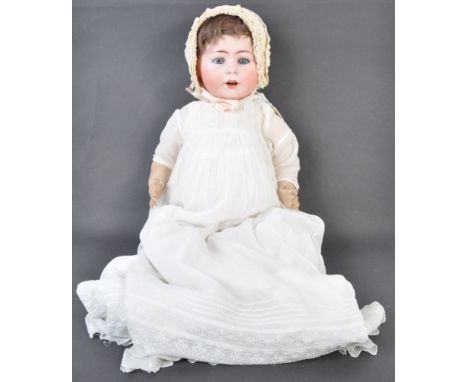 A charming antique early 20th century German bisque headed doll. The doll's face having blue flirty eyes,&nbsp;finely painted