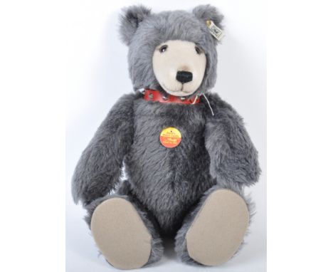 An original German made Steiff soft toy teddy bear from the ' Steiff's Watch Teddy ' range No. 606304. The bear having grey p