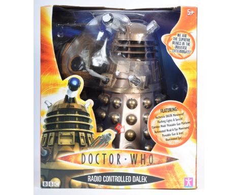 A Character Options made Radio Controlled Dalek boxed action figure. Gold. Factory sealed, the contents mint and unused. An i