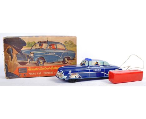 A rare vintage Wells Brimtoy ' Welsotoys ' made Battery Operated tinplate Police Car - ' Remote Control Battery Operated Poli