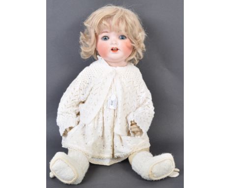 An antique early 20th century German Heubach Koppelsdorf made bisque headed doll. The doll having blue flirty eyes, finely pa