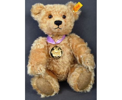 An original Steiff made soft toy teddy bear 660931 2003 Blonde Mohair bear with hand stitched details. Original gold button t