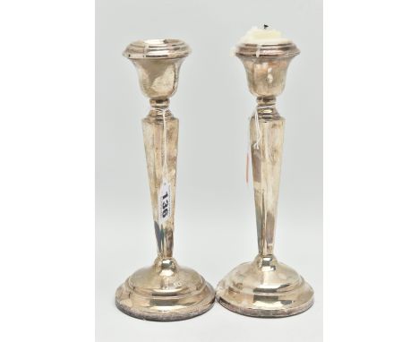 A PAIR OF SILVER CANDLE STICKS, tapered square columns on round weighted bases, hallmarks rubbed 'Sanders &amp; Mackenzie' Bi