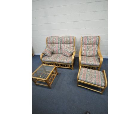 A WICKER FOUR PIECE CONSERVATORY SUITE, comprising a two seater sofa, length 131cm x depth 93cm x height 103cm, an armchair, 