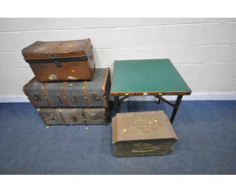 TWO CANVASS AND WOODEN BANDED TRAVELING TRUNKS, a domed metal tin trunk, a beaten brass box and a folding games table (condit