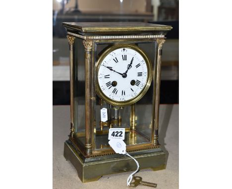 A BRASS FOUR GLASS MANTEL CLOCK, with mercury pendulum, enamel dial with Roman numerals and Arabic five minute demarcations, 