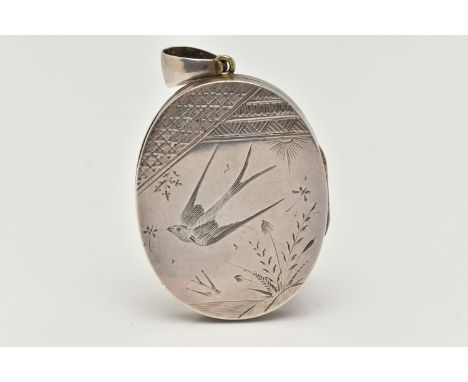 A VICTORIAN WHITE METAL LOCKET, oval form locket, etched with a swallow and foliage design to the front, floral design to the