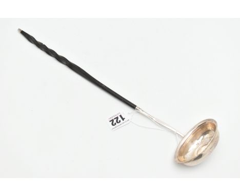 A WHITE METAL LADLE, set with a worn silver coin to the base, fitted with an ebonised handle (condition report: splitting to 