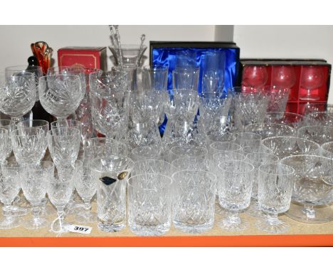 A QUANTITY OF CUT CRYSTAL, comprising a set of four large wine glasses, champagne flutes, a boxed red Bohemian glass vase, a 