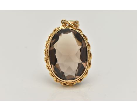 A 9CT GOLD SMOKEY QUARTZ PENDANT, set with an oval shaped mixed cut smoky quartz, within a rope twist border, hallmarked 9ct 