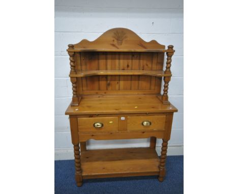 A MODERN PINE DRESSER, the top three tier plate rack with wheat decoration to crest, each shelf on barley twist supports, the