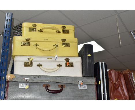A GROUP OF VINTAGE LUGGAGE, comprising two ladies yellow Antler suitcases, a cream Antler suitcase, a large grey trunk, two b