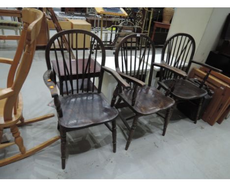 A set of three oak hoop and stick back armchairs