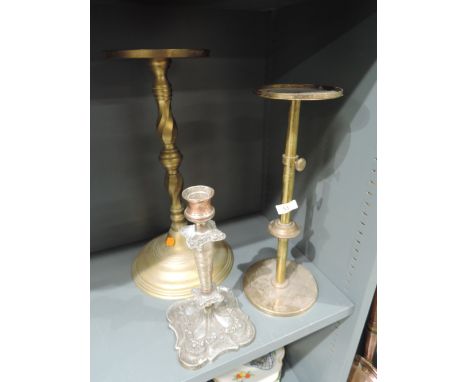 A selection of brass stands and plated candle stick